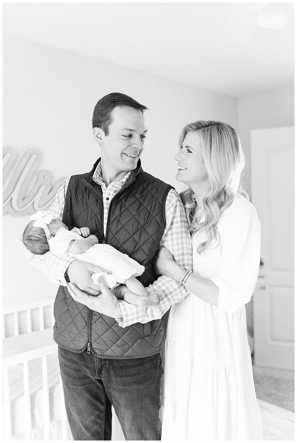 Photo of mom dad and baby in nursery taken by Fayetteville ar photographer grace Starr photography 